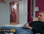 Brazzers features busty Georgie Lyall in a comfortable setting.